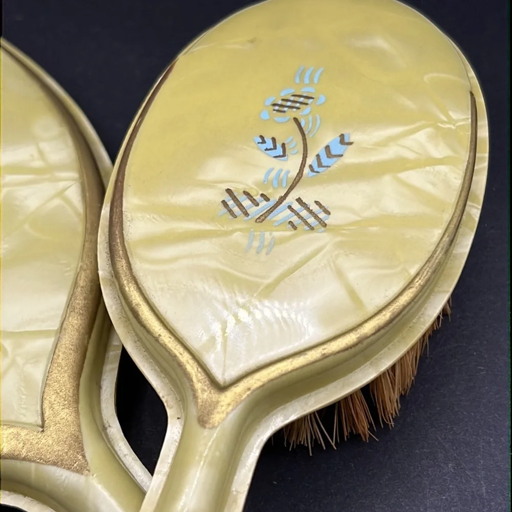 Vintage yellow celluloid vanity mirror, comb and brush set